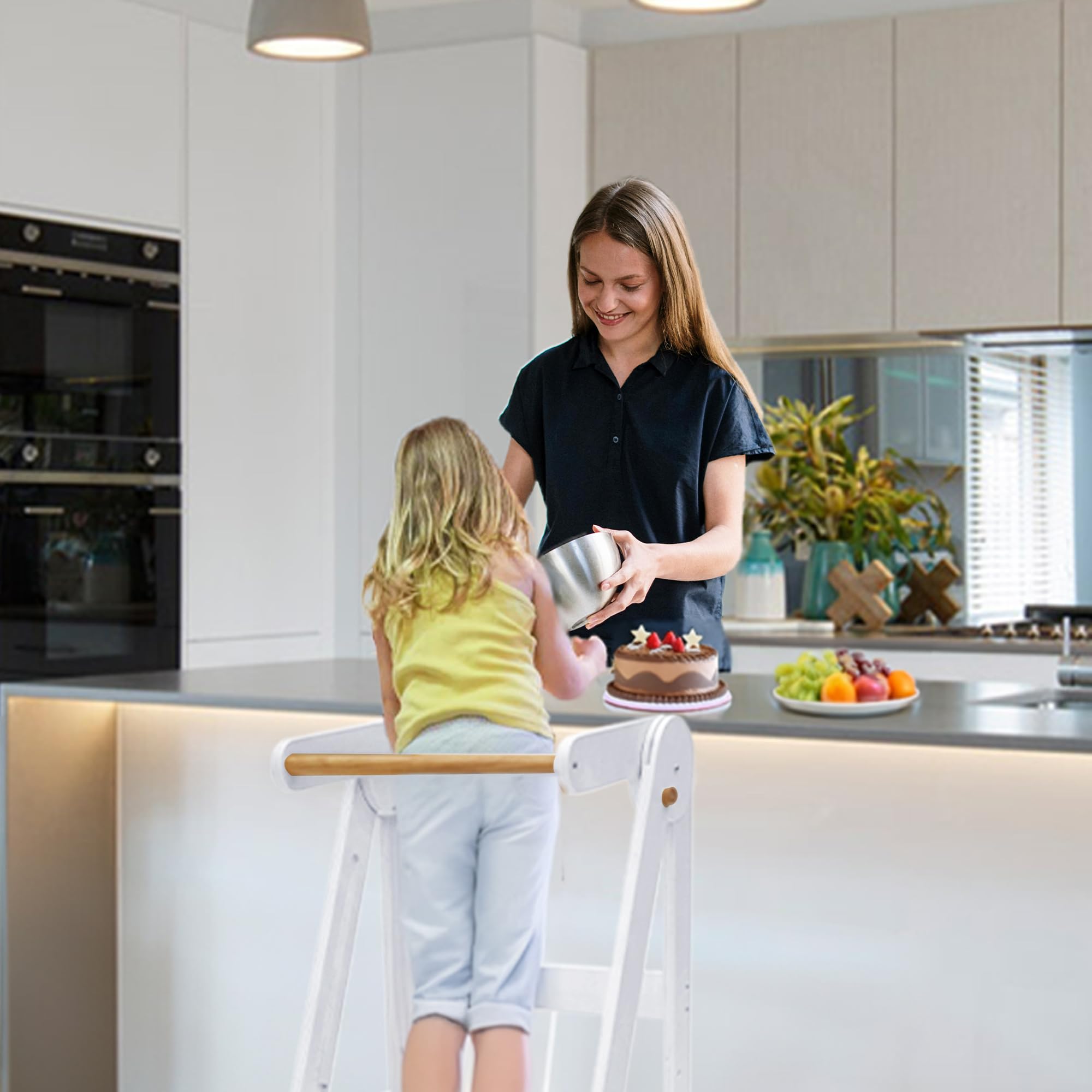 TDKDHoming foldable-toddler-tower in use for independent cooking tasks