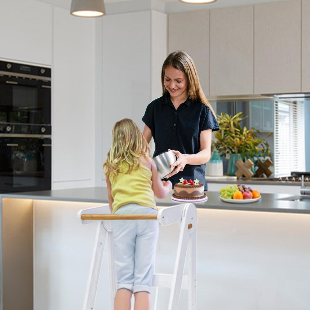 TDKDHoming foldable-toddler-tower in use for independent cooking tasks