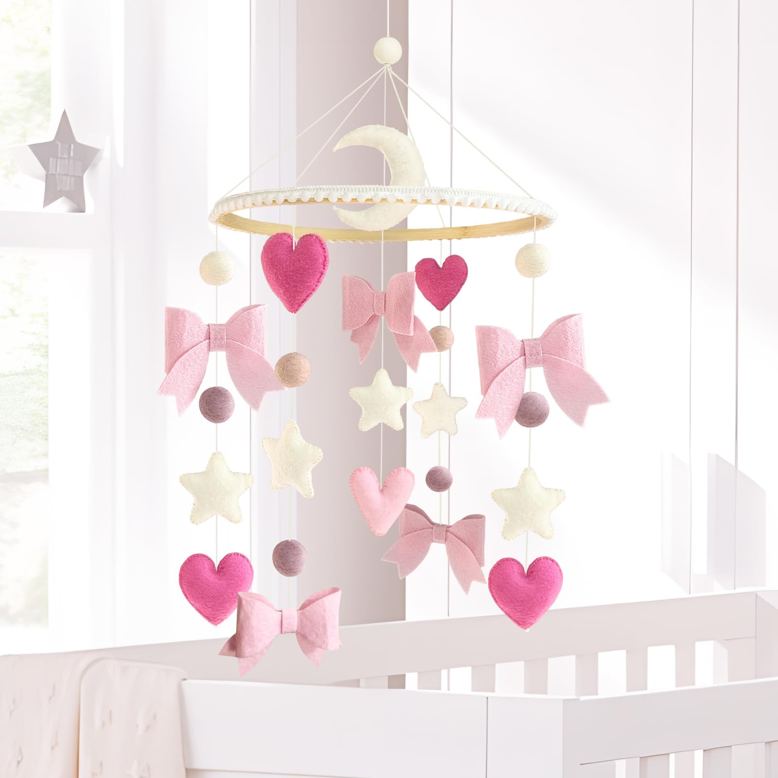 Teeloray pink bow moons stars design supports early visual development in baby's room.