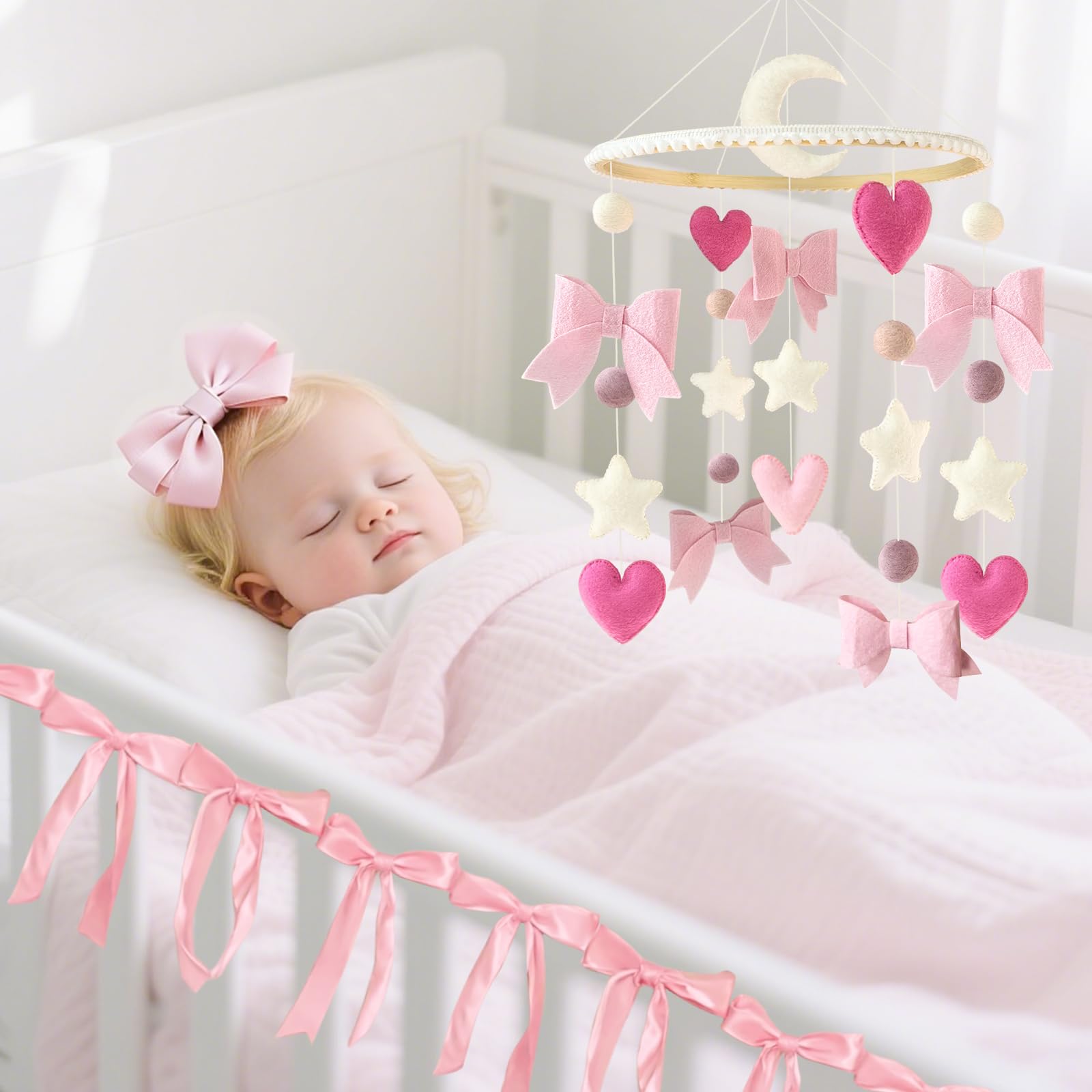 Teeloray mobile hanging setup shown in a cozy crib corner.