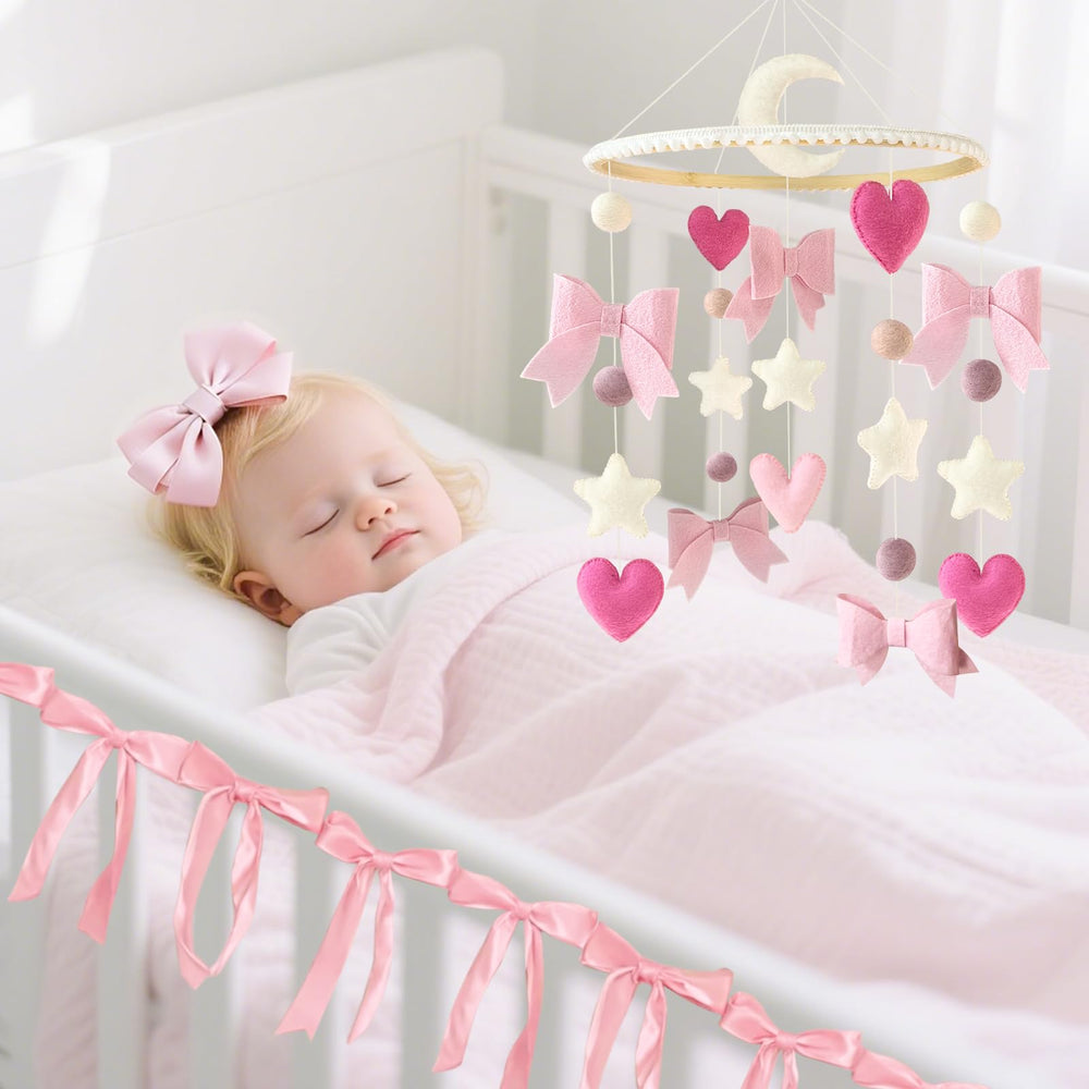Teeloray mobile hanging setup shown in a cozy crib corner.