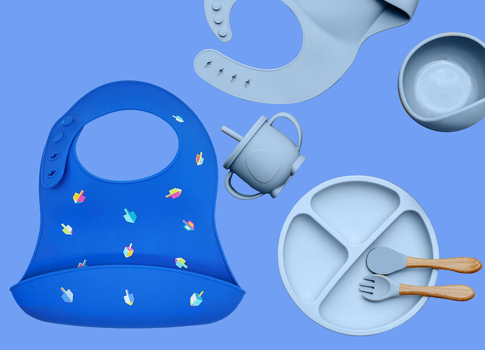 The Dreidel Company Hanukkah bib adjustable neck strap offers four sizes.