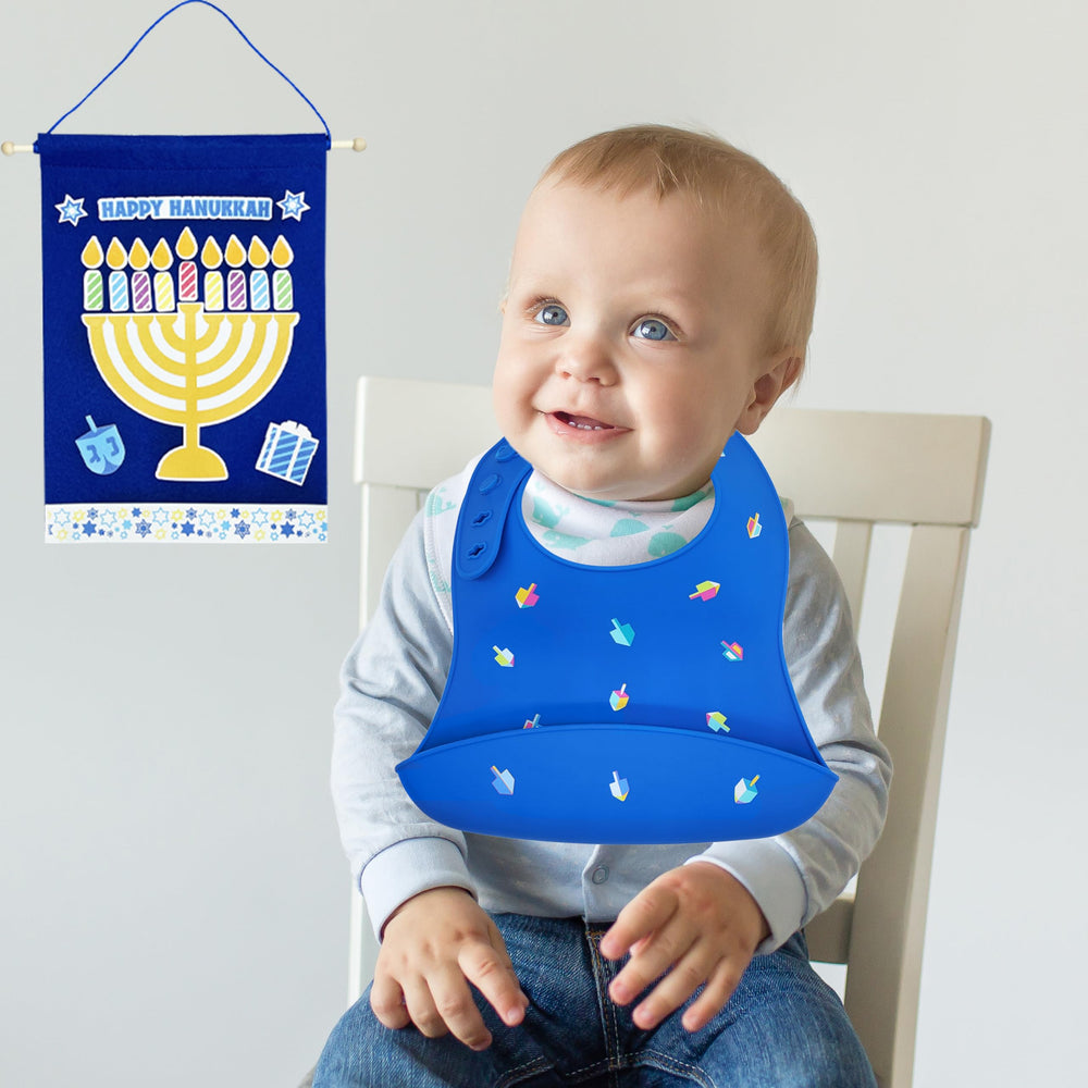 The Dreidel Company Hanukkah bib in use during feeding.