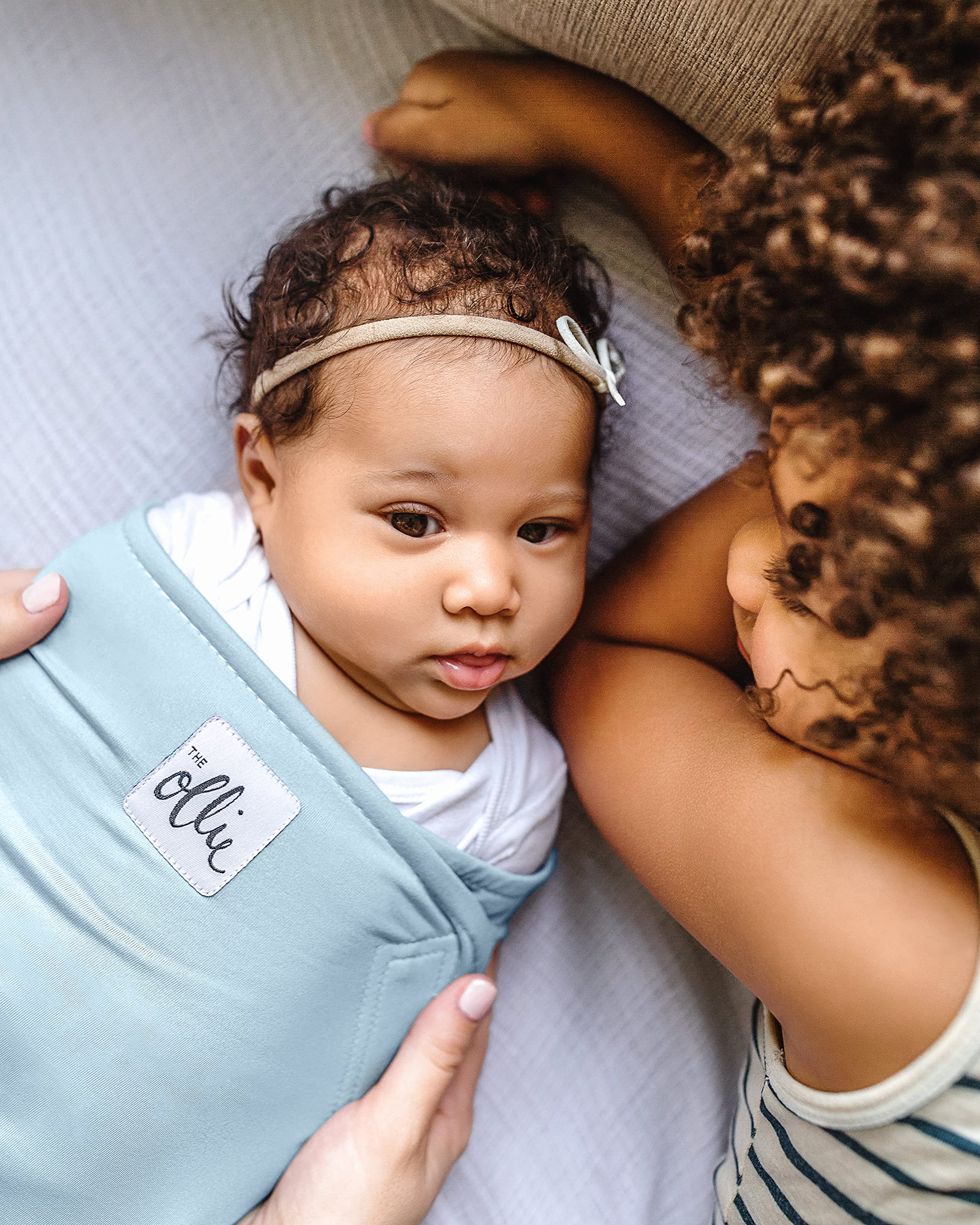 The Ollie Swaddle adjustable-fit grows with your baby for longer use.