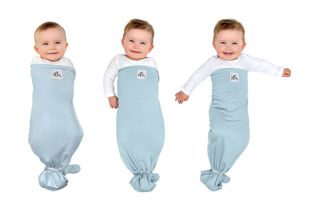The Ollie Swaddle with arms-in closure securely supports babies with adjustable fit.