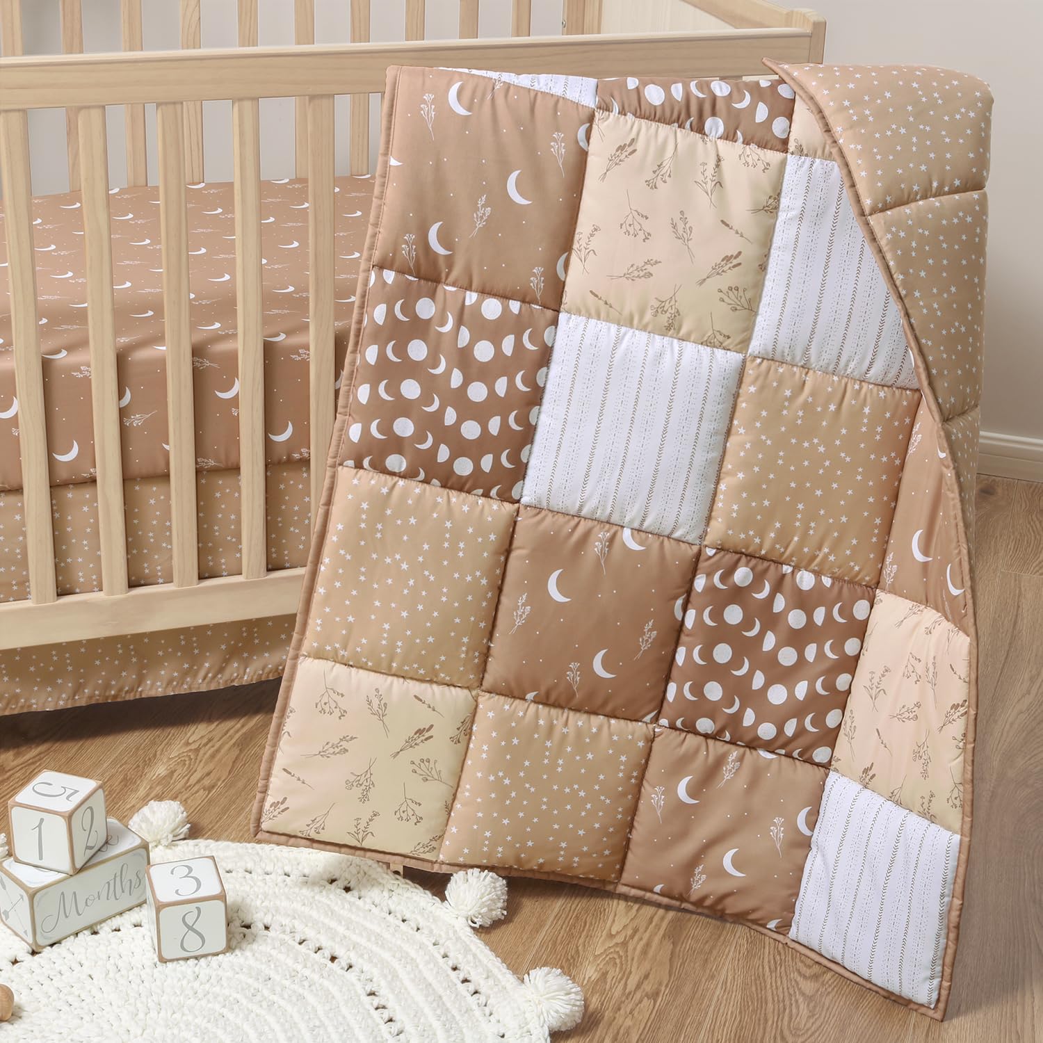 The Peanutshell celestial crib bedding quilt with stars adds cozy charm to the nursery.