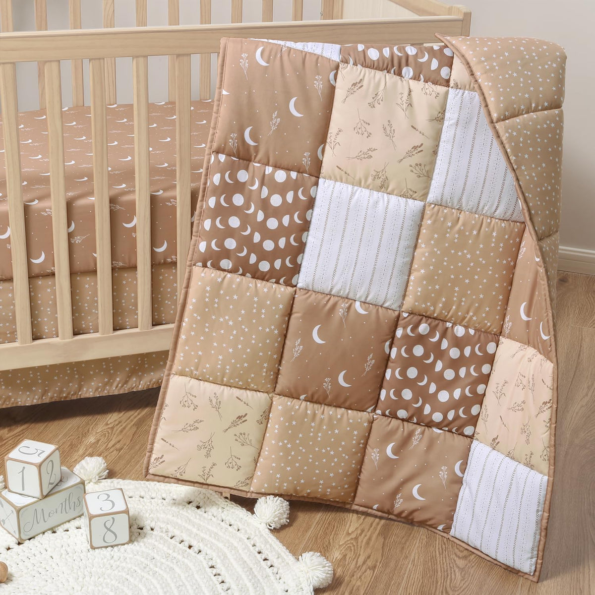 The Peanutshell celestial crib bedding quilt with stars adds cozy charm to the nursery.