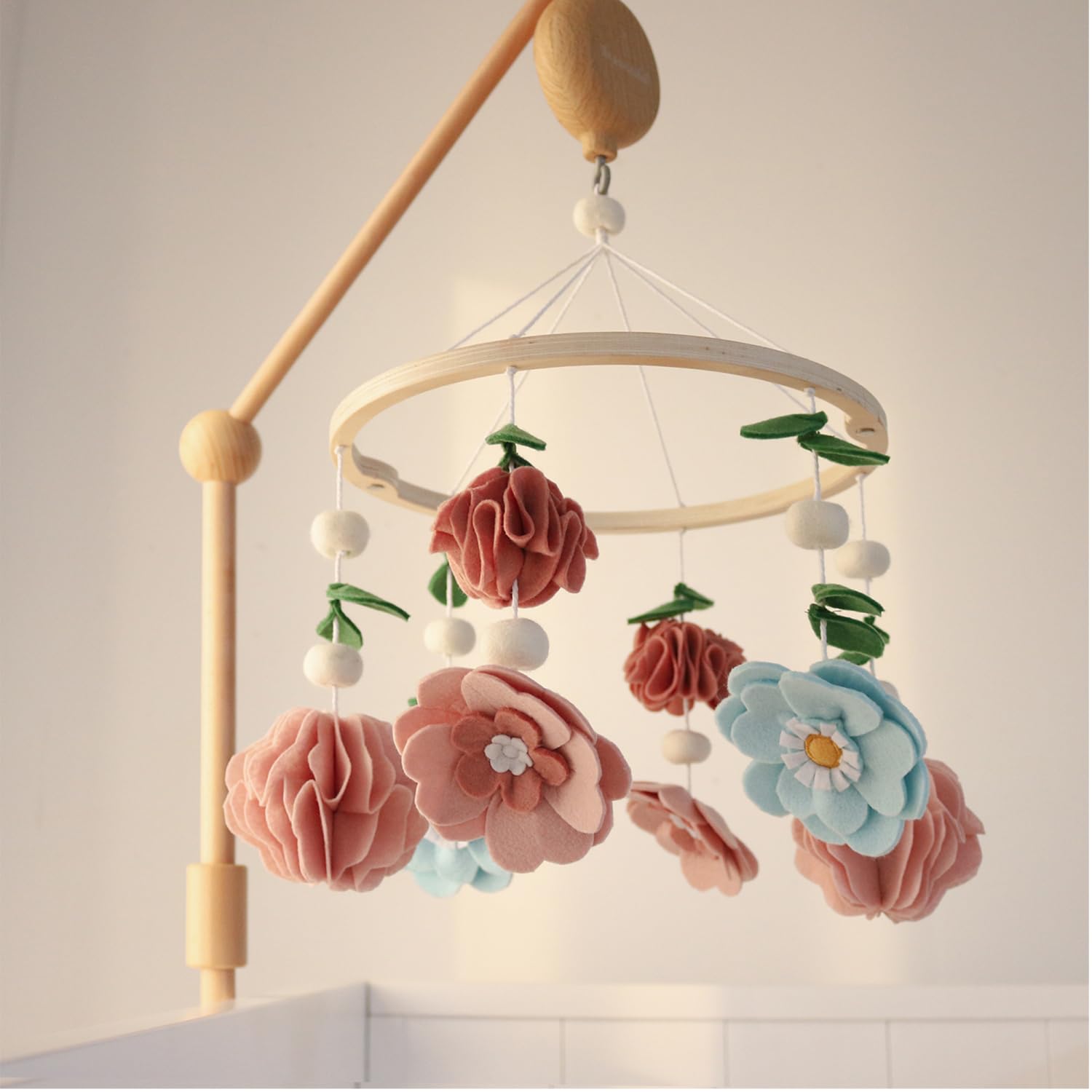 The Peanutshell crib mobile in pink, aqua, and green complements modern nurseries beautifully.