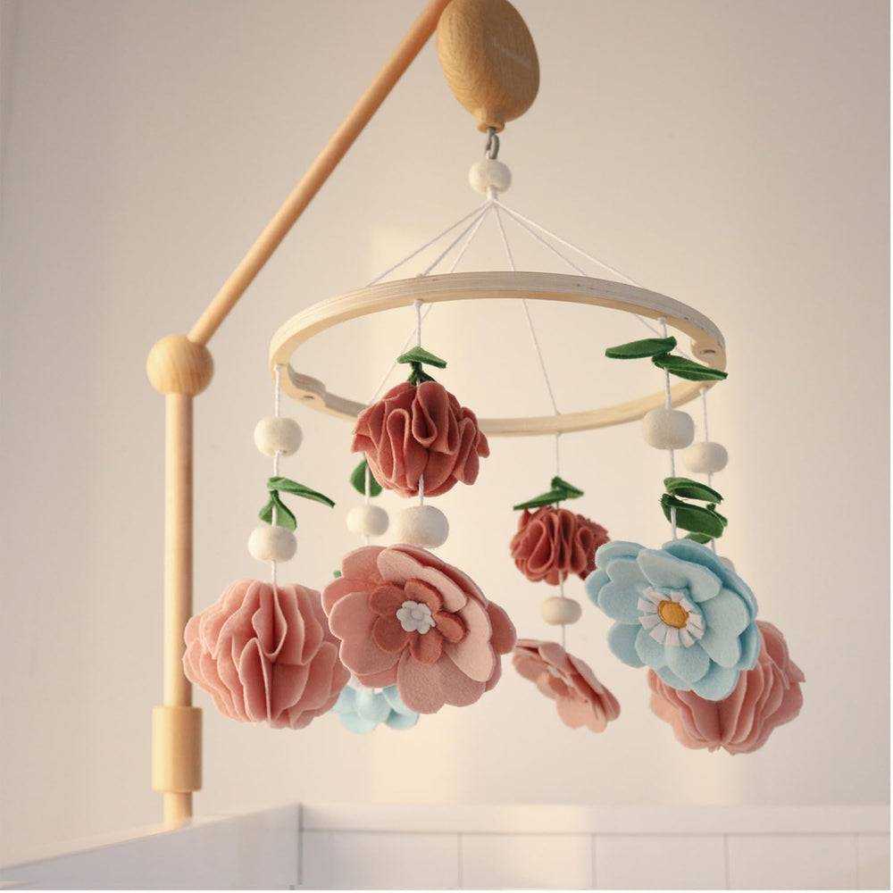 The Peanutshell crib mobile in pink, aqua, and green complements modern nurseries beautifully.
