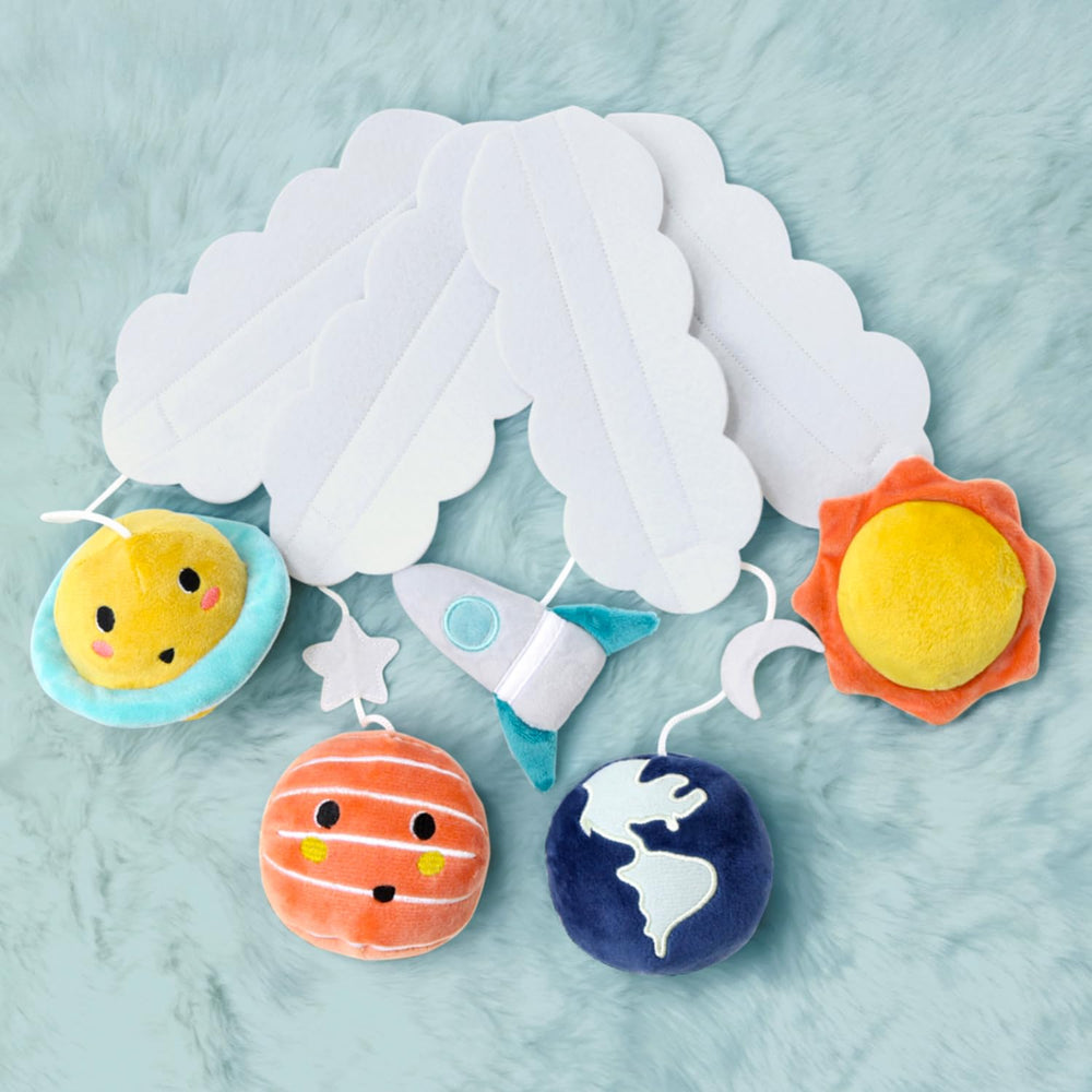 The Peanutshell crib mobile adds playful space-inspired decor.