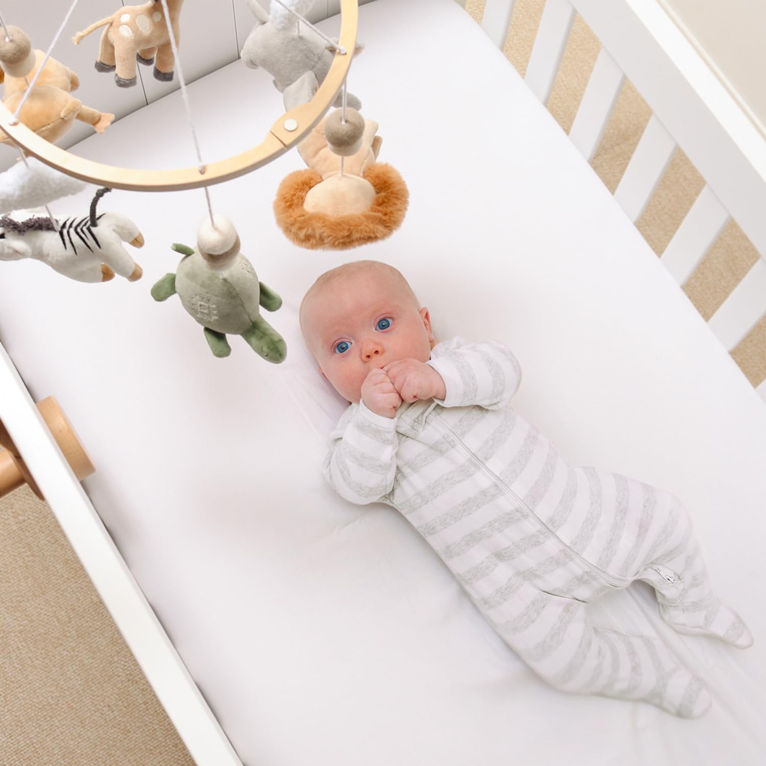 The Peanutshell wooden frame mobile fits standard cribs for quick setup and storage.