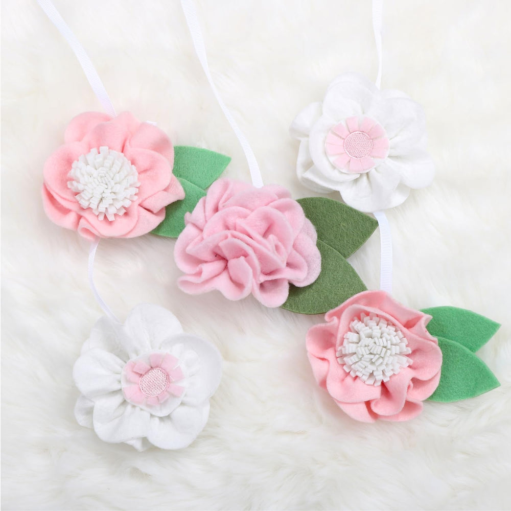 The Peanutshell pink-bloom mobile brightens the nursery while soothing.