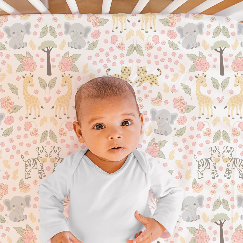 The Peanutshell Wildest Dreams bed skirt in pink and white creates a finished nursery look.