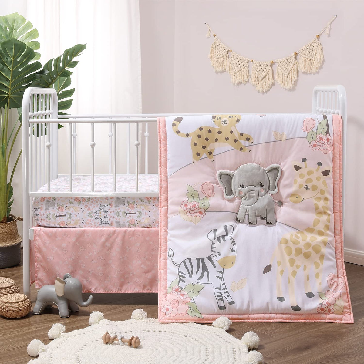 The Peanutshell Wildest Dreams quilt featuring safari animals adds cozy color to a nursery.