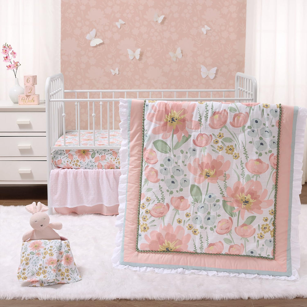 The Peanutshell Wildflower crib bedding ensemble showcases pink and mint florals for a cozy nursery.