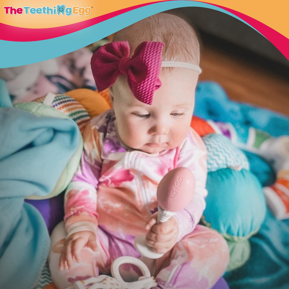 The Teething Egg clip with detachable Grippie Stick keeps it close.