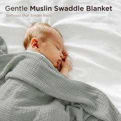 Threadmill Muslin blanket wrapped around newborn for secure, cozy swaddle.