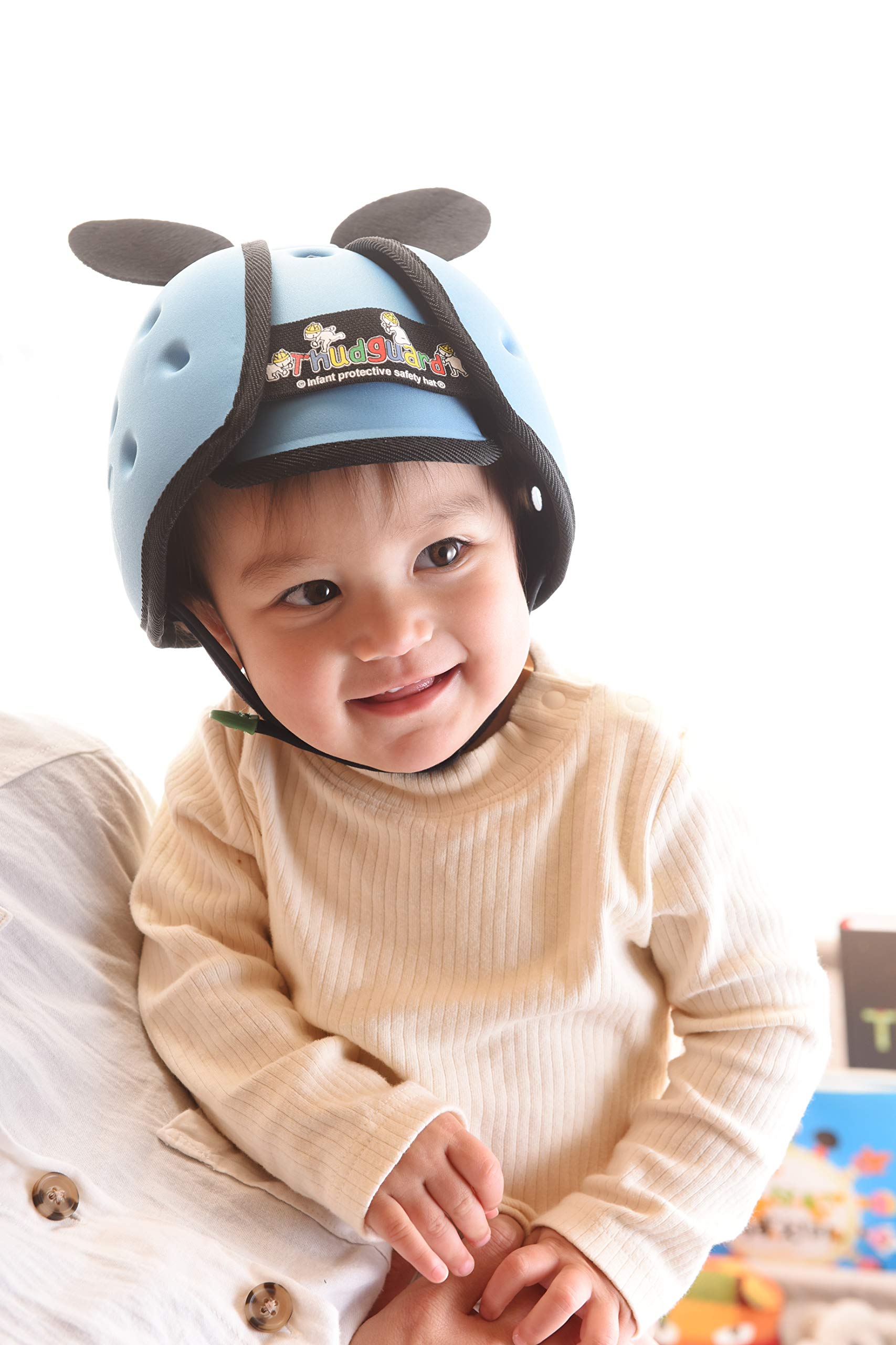 Thudguard blue infant hat side view highlighting adjustable strap and comfort.