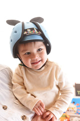 Thudguard blue infant hat side view highlighting adjustable strap and comfort.