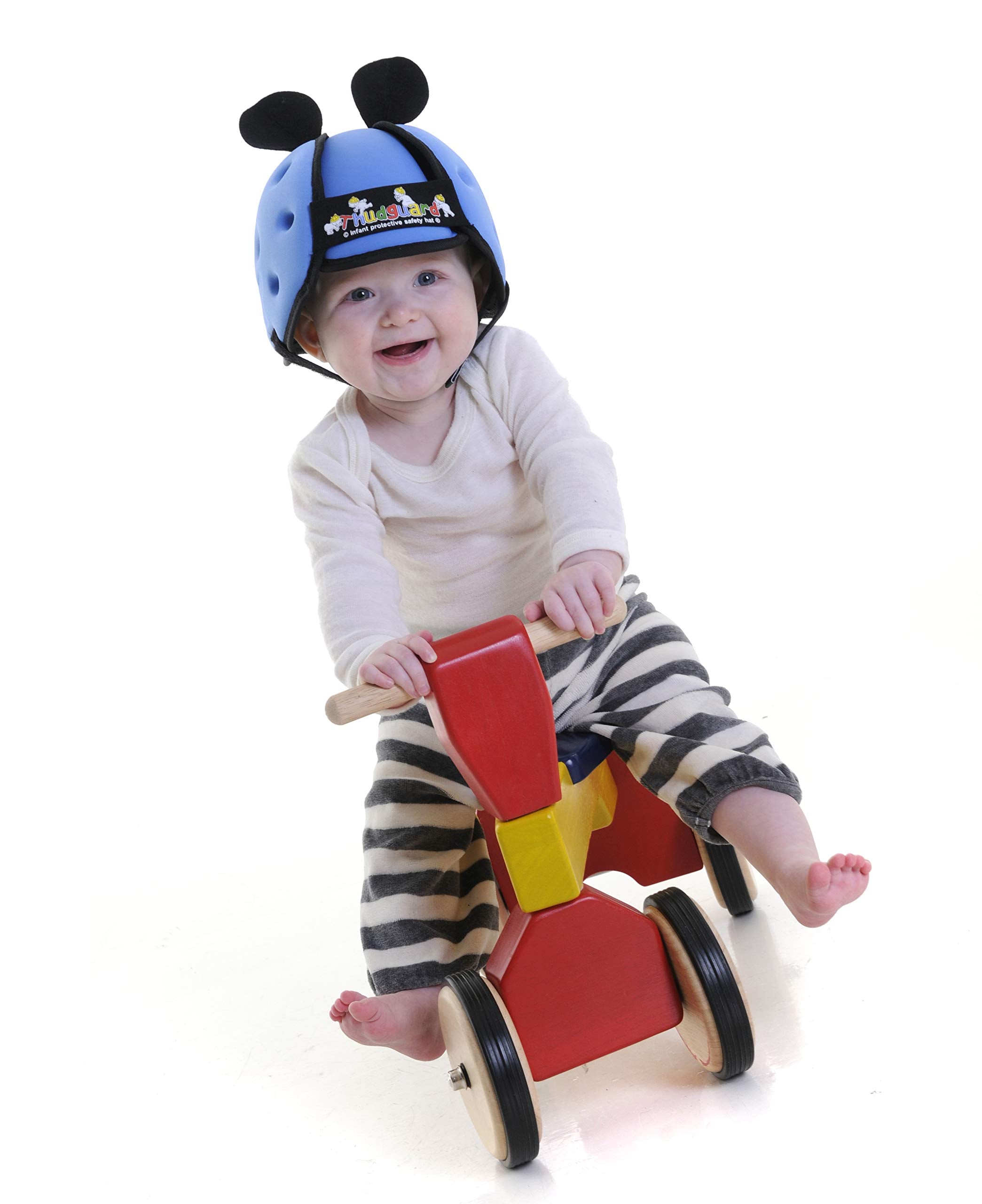 Thudguard blue infant hat worn by toddler during playtime.