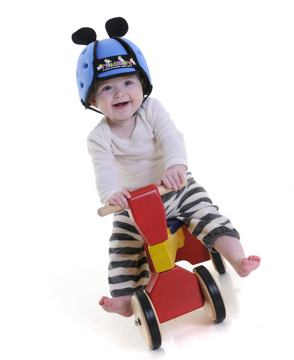 Thudguard blue infant hat worn by toddler during playtime.