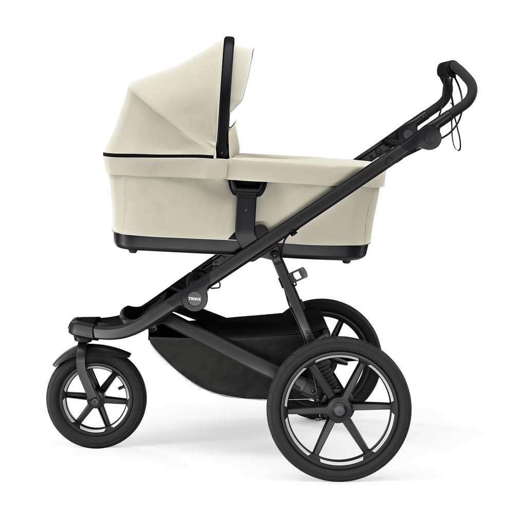 Thule Bassinet Soft Beige extended canopy protects baby from sun and wind.