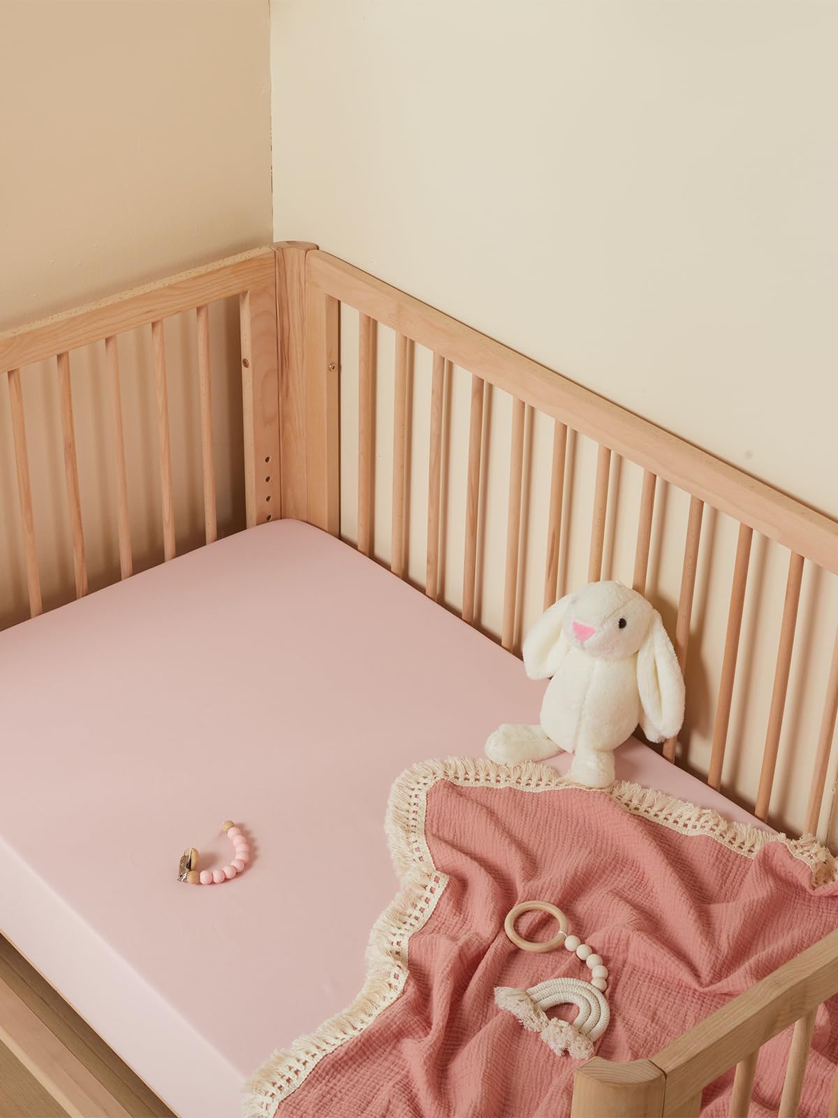 TILLYOU baby crib sheet light pink closeup highlights cozy, breathable weave for restful sleep