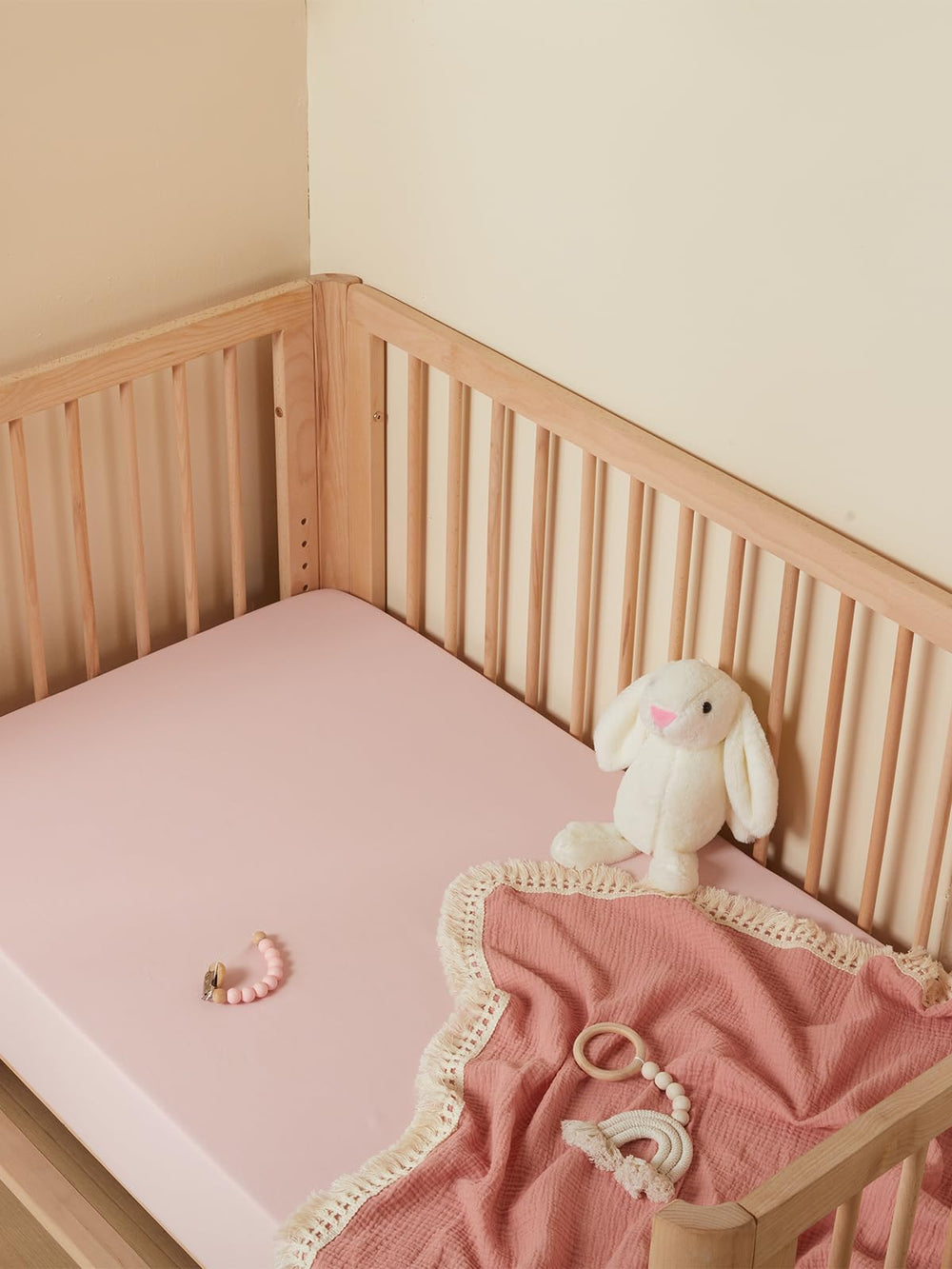 TILLYOU baby crib sheet light pink closeup highlights cozy, breathable weave for restful sleep