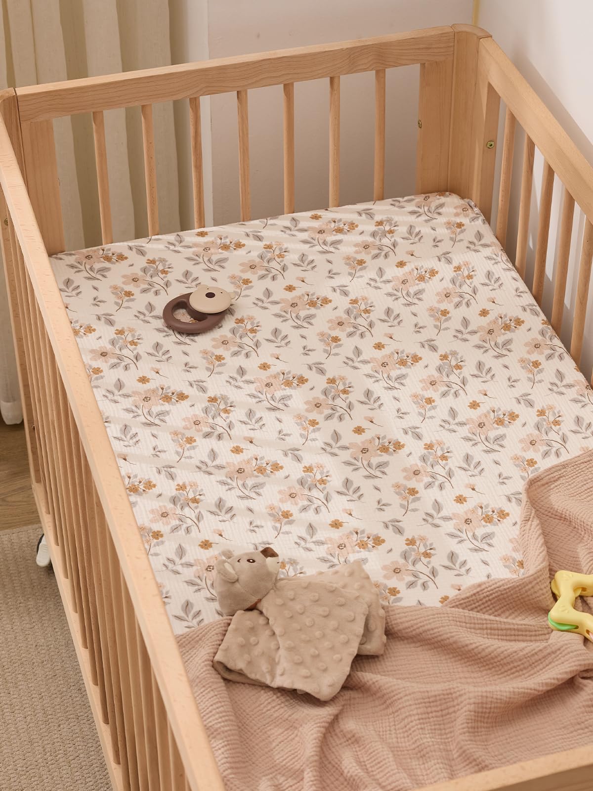 TILLYOU muslin crib sheets yellow flower on bed demonstrates secure wrap for 52x28 crib.