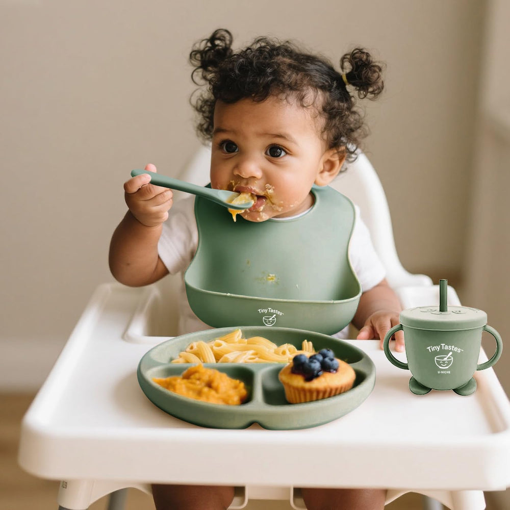 Tiny Tastes soft spoon beside a plate for comfortable feeding