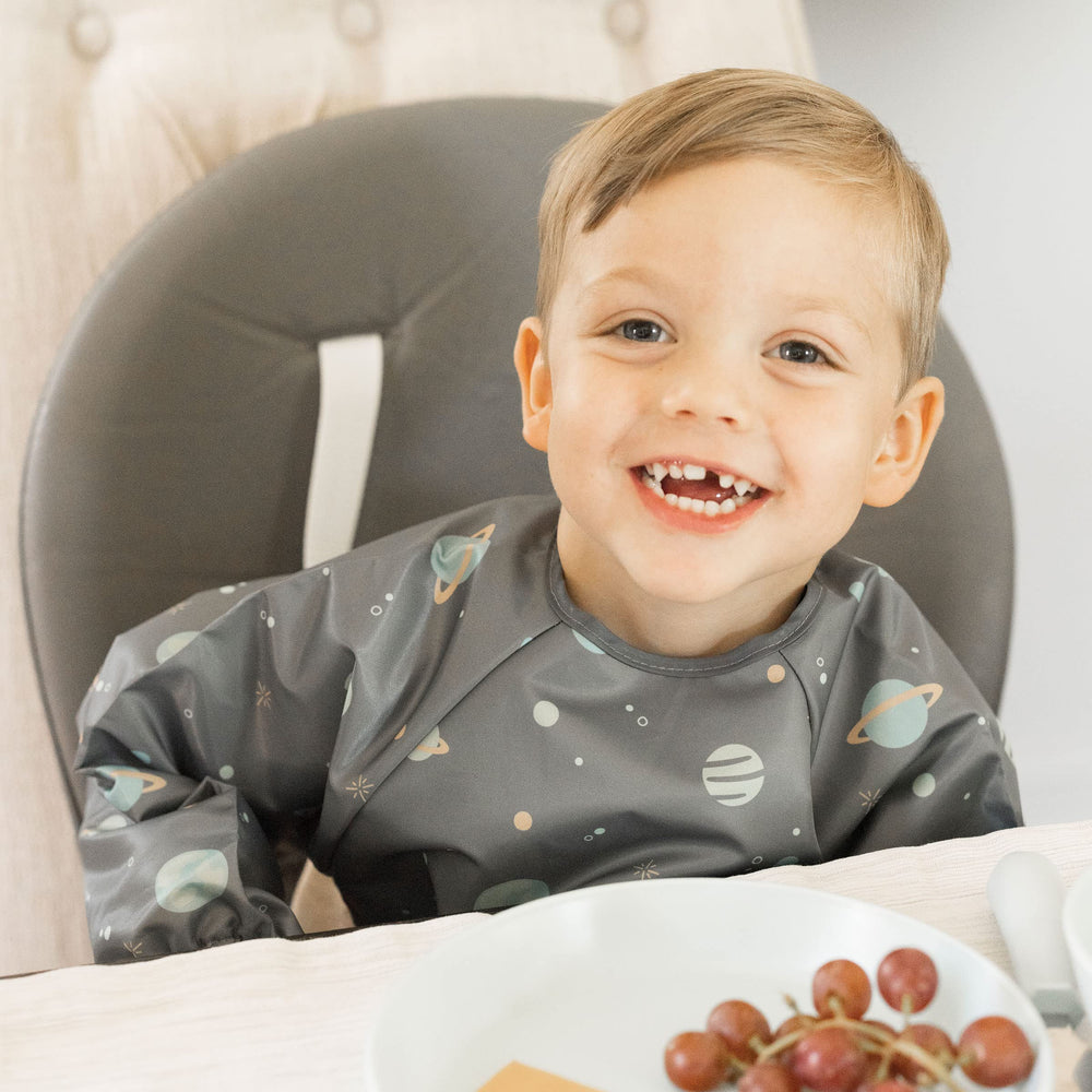Tiny Twinkle bib close-up with elastic cuffs demonstrates comfortable, spill-proof fit.