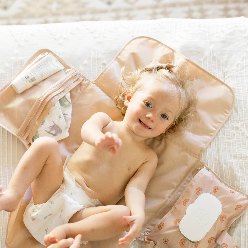 Tiny Twinkle changing pad with organized pockets for diapers and creams