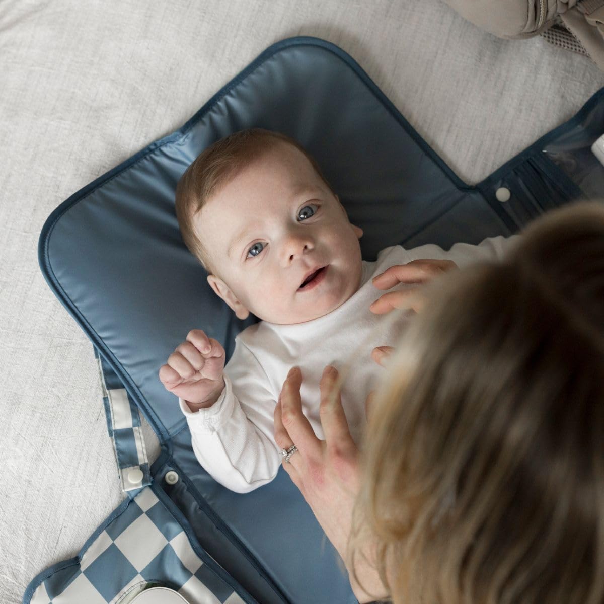 Tiny Twinkle changing pad with organized storage for diapers and creams.