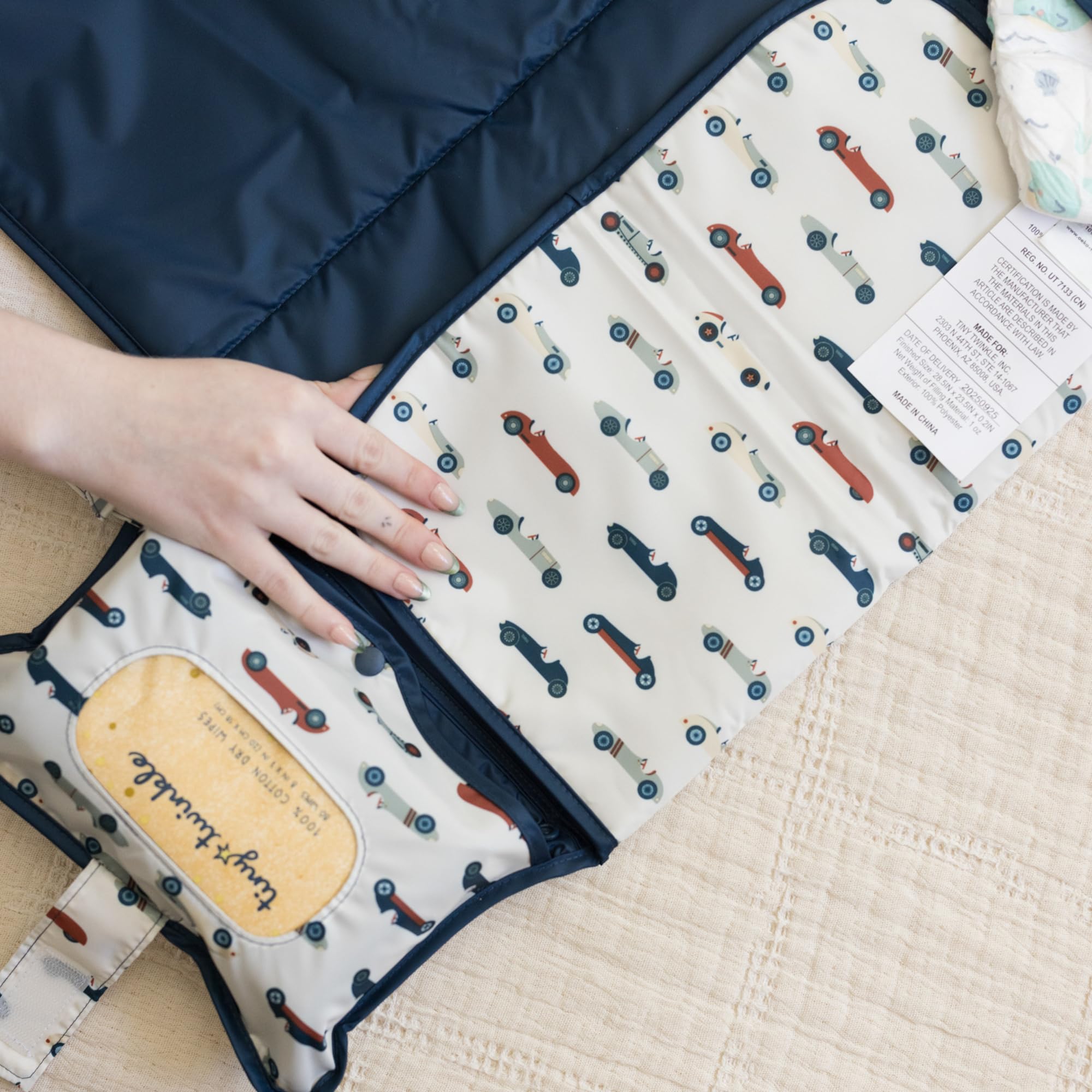 Tiny Twinkle storage pockets keep diapers and creams organized and within reach.