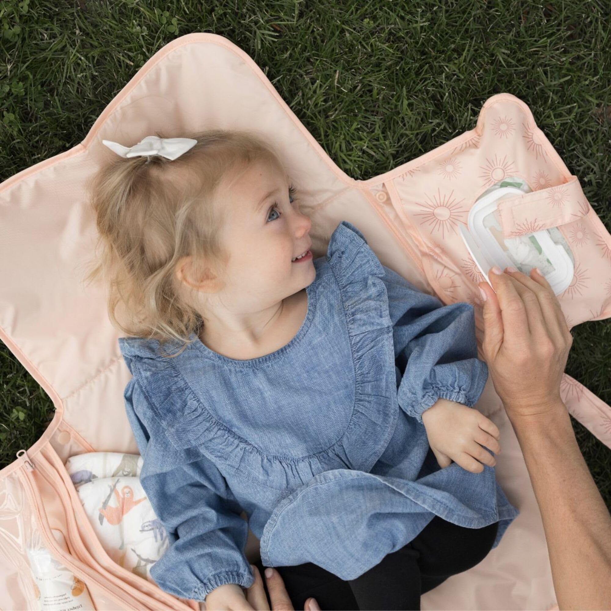 Tiny Twinkle changing pad attached to stroller clip for secure transport