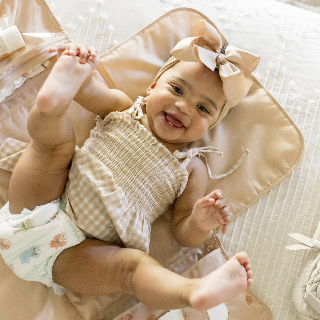 Tiny Twinkle changing pad clips to a stroller for hands-free changes