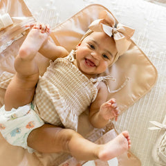 Tiny Twinkle changing pad clips to a stroller for hands-free changes