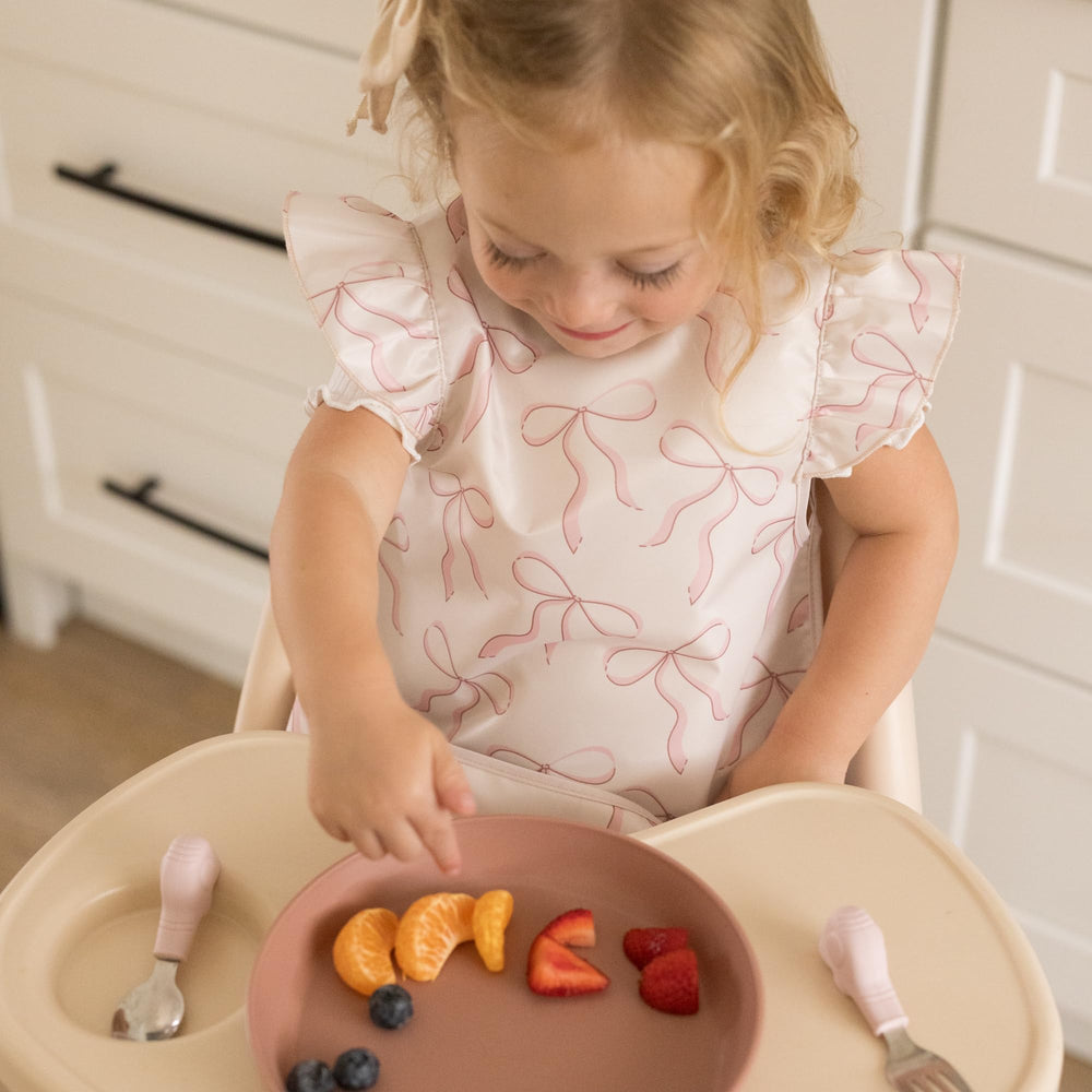Tiny Twinkle food pocket open bib traps crumbs while feeding