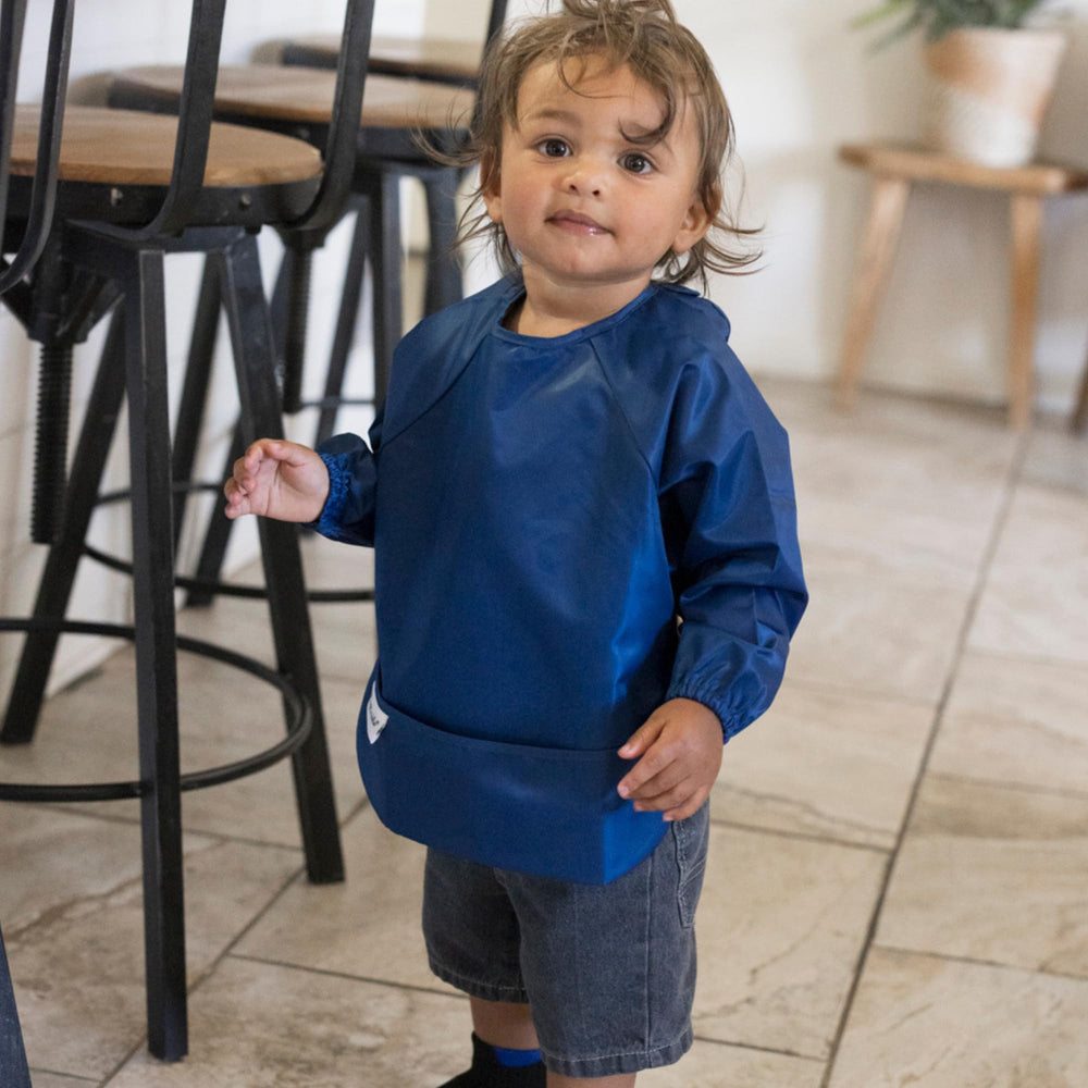 Tiny Twinkle long sleeve bib grey indigo wipe-clean surface in action.
