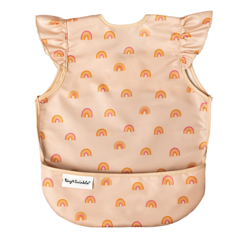 Tiny Twinkle mess-proof bib with boho rainbow design protects outfits during mealtime.