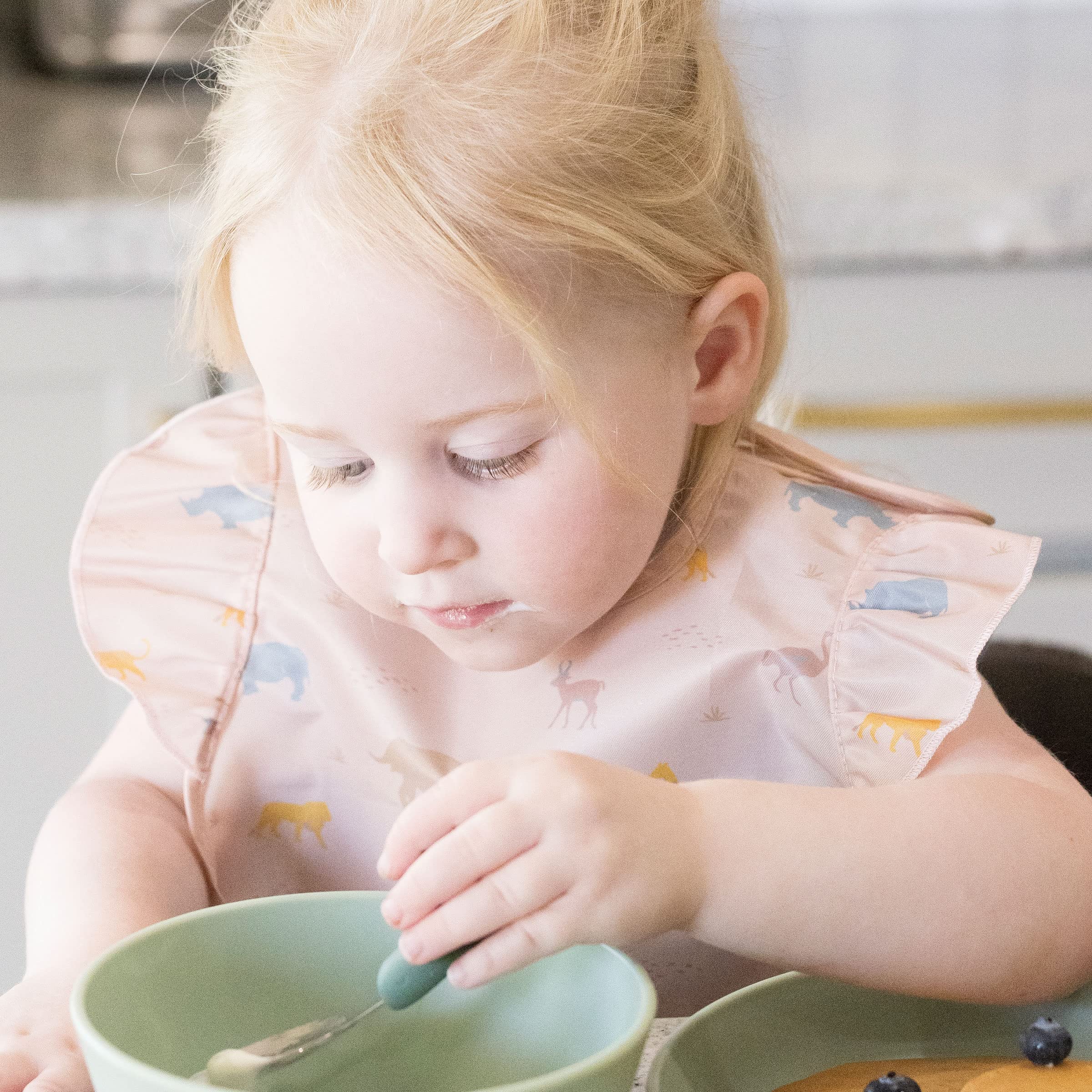 Tiny Twinkle Mess-Proof Bib is made from durable material for everyday use.