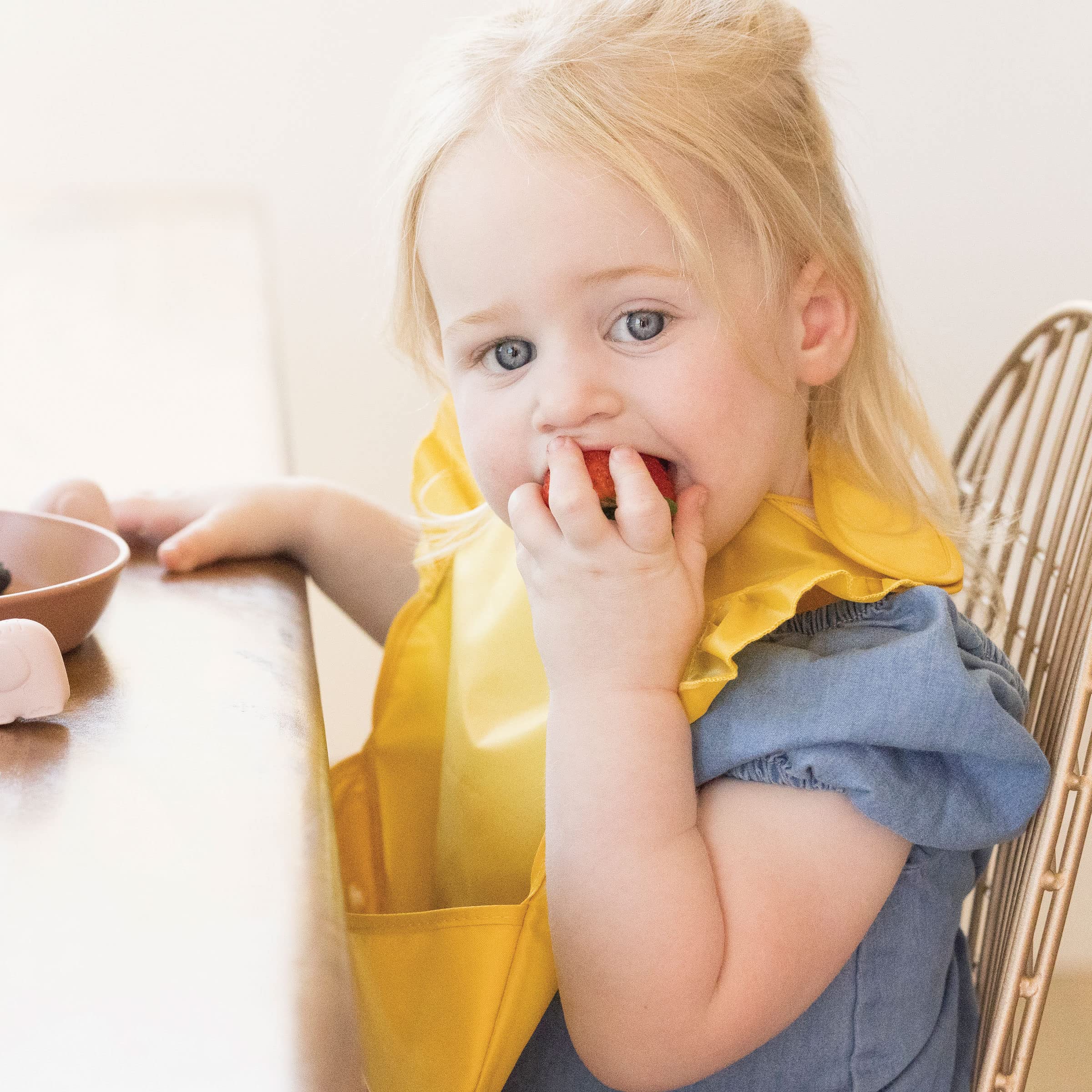 Tiny Twinkle Mess-Proof Bib features easy-on, easy-off closure for quick outfit changes.