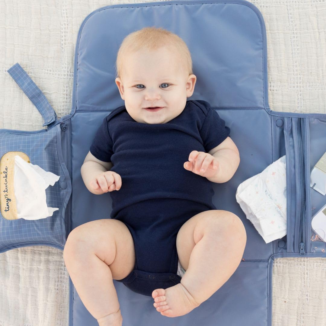Tiny Twinkle changing pad with wipes pocket enables quick wipe access.