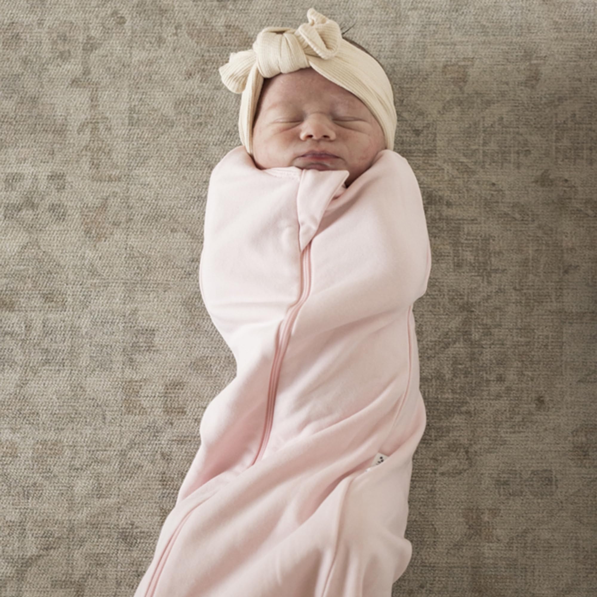 Tiny Twinkle sleep sack with secure snaps enables quick swaddle-to-sleep transition.