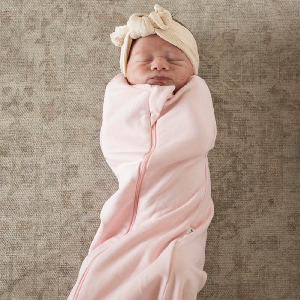 Tiny Twinkle sleep sack with secure snaps enables quick swaddle-to-sleep transition.