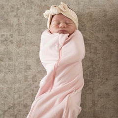 Tiny Twinkle sleep sack with secure snaps enables quick swaddle-to-sleep transition.