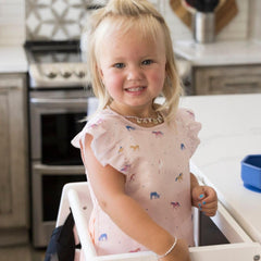 Tiny Twinkle waterproof bib fabric closeup showing leak protection for messy eaters