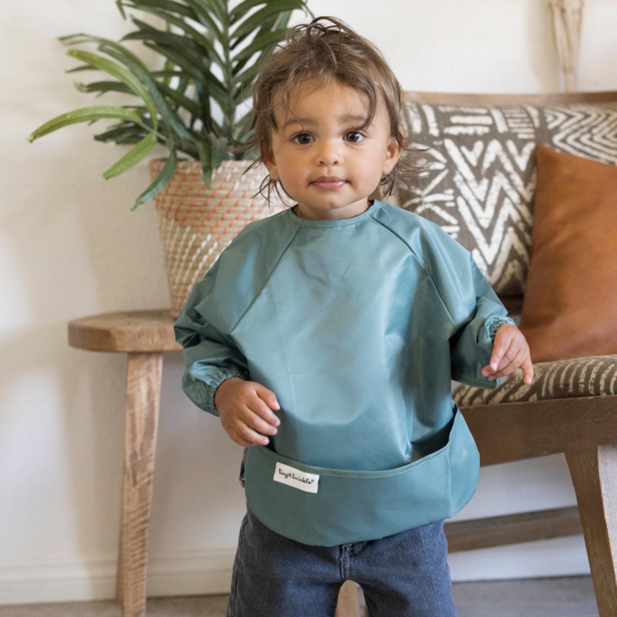 Tiny Twinkle waterproof bib with full-body coverage protects outfits during feeding.