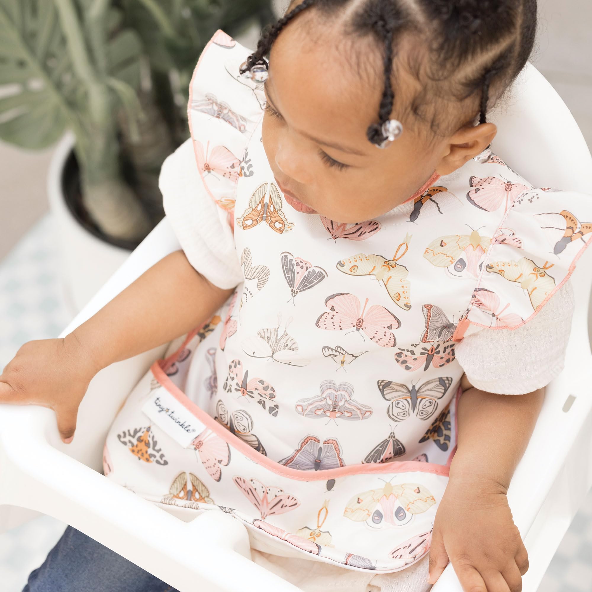 Tiny Twinkle waterproof toddler bib prevents spills and splashes.