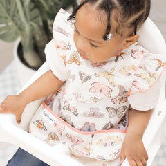 Tiny Twinkle waterproof toddler bib prevents spills and splashes.